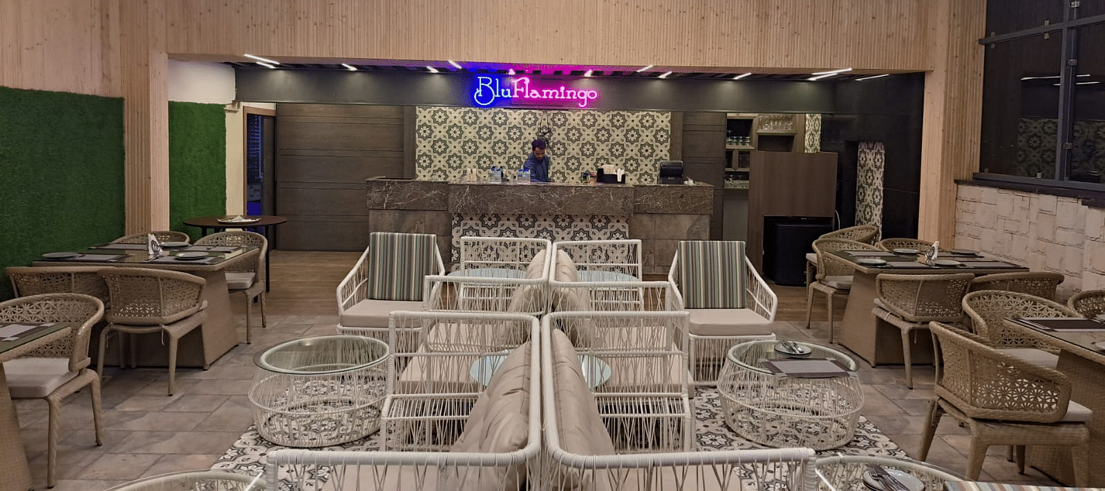 Rooftop lounge featuring illuminated Blu Flamingo logo with ambient lighting at BluSalzz Residence, Amritsar